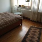 bedroom featuring hardwood flooring and radiator