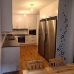 kitchen with oven, microwave, stainless steel refrigerator, white cabinetry, dark countertops, and light flooring