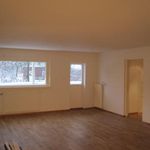empty room with a healthy amount of sunlight and hardwood flooring