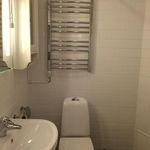 bathroom featuring tile flooring, radiator, and sink