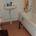 half bathroom with hardwood floors, washer / dryer, toilet, and sink
