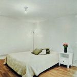 bedroom with hardwood flooring and radiator