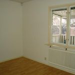 spare room featuring a healthy amount of sunlight, hardwood flooring, and radiator