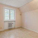 spare room with tile floors, natural light, and radiator