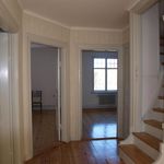 hallway with parquet floors, natural light, and radiator