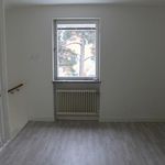 empty room featuring parquet floors, natural light, and radiator