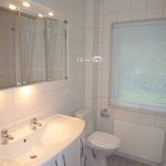 half bathroom featuring tile flooring, radiator, large vanity, toilet, and mirror