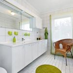 half bath with tile floors, large vanity, toilet, and mirror