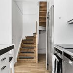 stairs with hardwood floors, oven, and electric stovetop