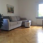 living room featuring parquet floors, natural light, TV, and radiator
