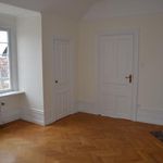 empty room with parquet floors, natural light, and radiator
