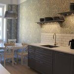 kitchen featuring natural light, light countertops, dark floors, and dark brown cabinets