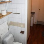 bathroom featuring hardwood flooring and toilet