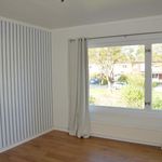 spare room featuring plenty of natural light, hardwood floors, and radiator