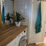 laundry room with tile flooring and washer / dryer