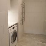 washroom with tile flooring and washer / dryer