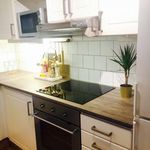 kitchen with oven, exhaust hood, electric cooktop, white cabinetry, dark countertops, and dark hardwood flooring