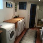 washroom with parquet floors and washer / dryer