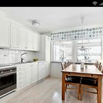 kitchen featuring natural light, electric cooktop, stainless steel oven, white cabinets, light hardwood floors, and light countertops
