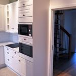 kitchen with microwave, oven, white cabinets, dark countertops, and dark floors