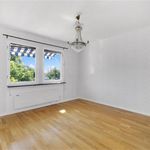 empty room with natural light and hardwood flooring