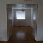 hallway with natural light, hardwood flooring, and radiator