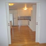 hallway with hardwood floors, dishwasher, and refrigerator