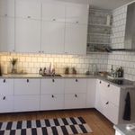 kök med parkettgolv, vita skåp, lätt golv, och mörka bänkskivor