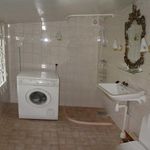 bathroom with tile flooring, washer / dryer, mirror, and washbasin