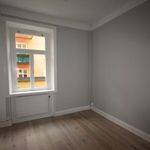 spare room with parquet floors, natural light, and radiator