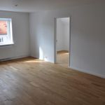 spare room featuring natural light, hardwood flooring, and radiator