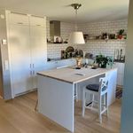 kitchen featuring range hood, white cabinets, pendant lighting, light countertops, and light parquet floors
