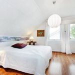 bedroom featuring parquet floors, vaulted ceiling, and natural light
