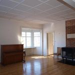 miscellaneous room featuring parquet floors, natural light, exposed bricks, and radiator