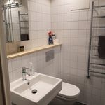 half bathroom featuring tile flooring, vanity, toilet, and mirror