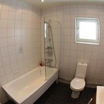 bathroom with natural light, tile floors, toilet, and shower / washtub combination