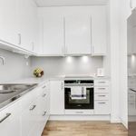 kitchen with oven, refrigerator, white cabinets, light countertops, and light parquet floors