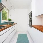 walk in closet / pantry with natural light, tile flooring, oven, and electric cooktop