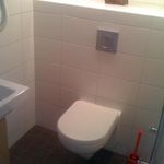 bathroom with tile flooring and toilet