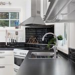 kitchen with natural light, extractor fan, range oven, stainless steel finishes, dark countertops, and white cabinetry