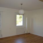 empty room with a wealth of natural light, hardwood floors, and radiator