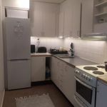 kitchen with electric range oven, refrigerator, range hood, dark hardwood flooring, light countertops, and white cabinetry