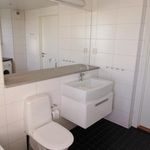 half bathroom with tile floors, vanity, toilet, and mirror