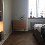 bedroom featuring natural light, hardwood floors, and radiator