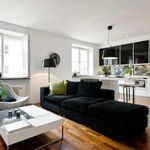 living room featuring plenty of natural light, hardwood floors, and radiator