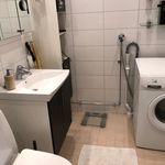 half bathroom with tile floors, washer / dryer, toilet, oversized vanity, and mirror