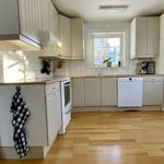 kitchen featuring natural light, range oven, dishwasher, white cabinets, light hardwood flooring, and pendant lighting