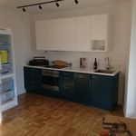 kitchen with oven, dark brown cabinets, dark hardwood floors, and light countertops