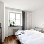 bedroom featuring natural light, hardwood flooring, and radiator