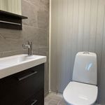 half bathroom with tile floors, toilet, and vanity